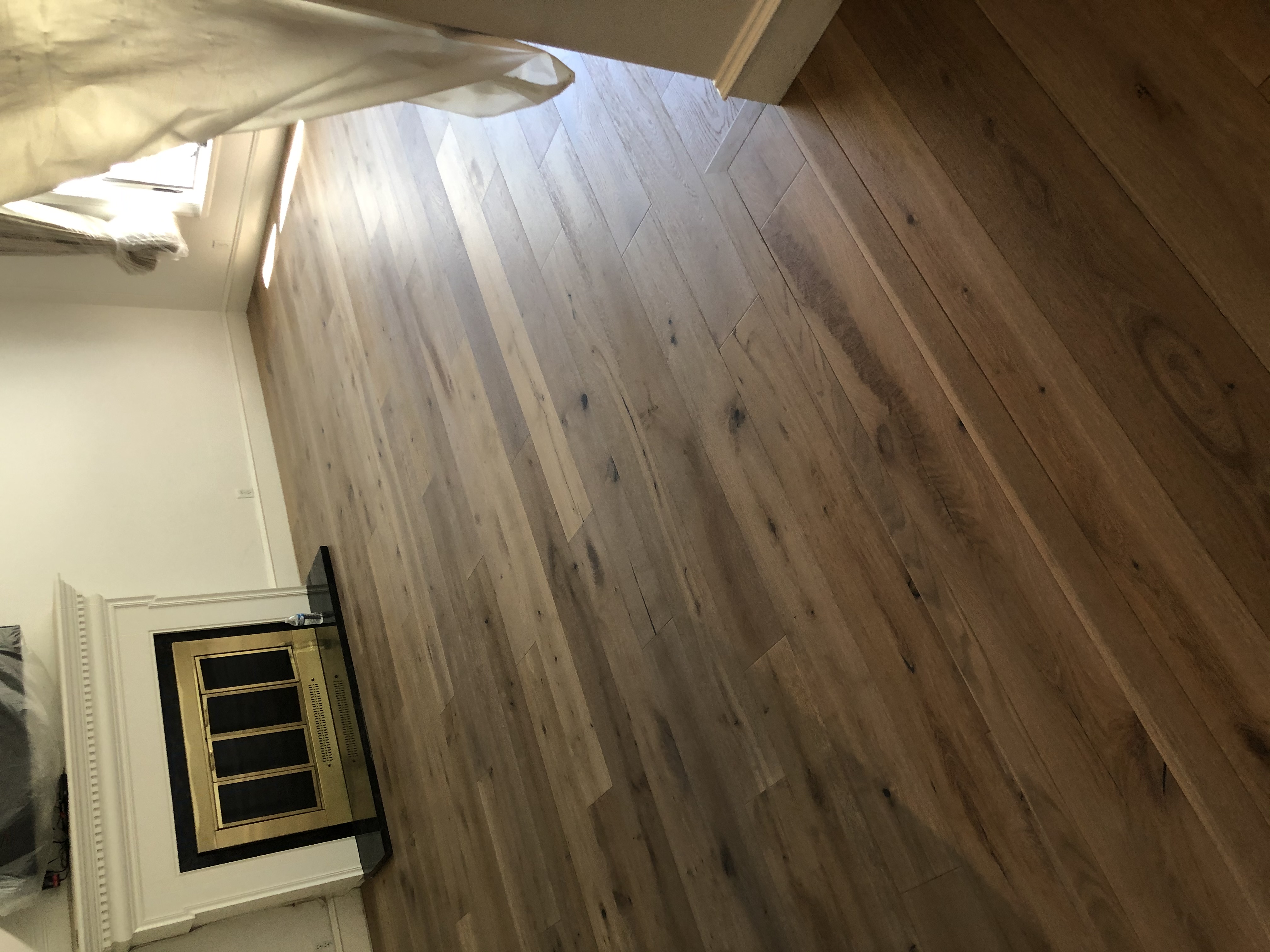 Restored floors show their beauty through reflected light. The floors after restoration brought new life to the living room.