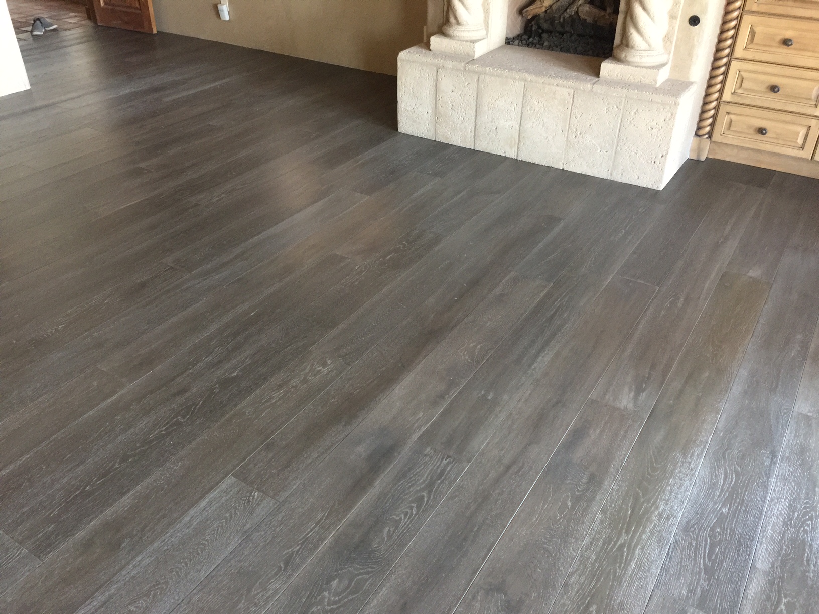 Hardwood flooring througout this home makes for a consistent and comfortable feeling no matter what the accents or lighting are. The wood accents the marble fireplace and really makes the beautiful installation stand out.